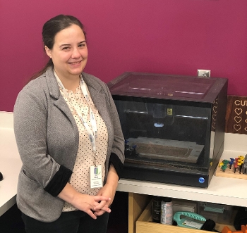 Nora Bahr, Maker space librarian for Huntsville-Madison County Public Library, standing next to the Carvey CNC milling machine