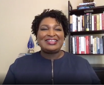 screen shot of Stacey Abrams in front of bookcase