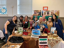 Louisville librarians and community members with laptops, decorations for International Women's Day
