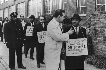 b&w photo of man interviewing Martin Luther King standing on picket line