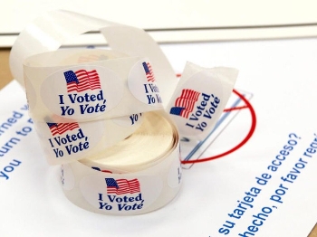 roll of voting stickers in English and Spanish