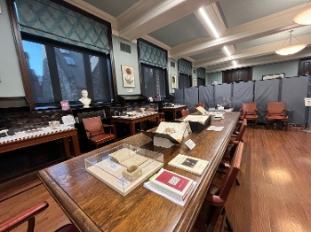 interior of room with long table displaying books