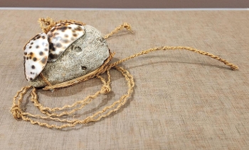 lure made of stone, rope, wood, and spotted shells
