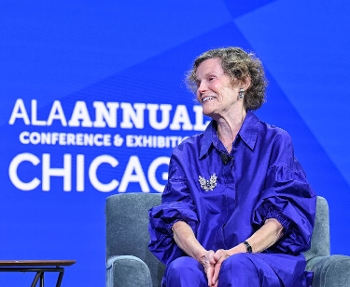 Judy Blume, smiling, seated against blue background with ALA logo