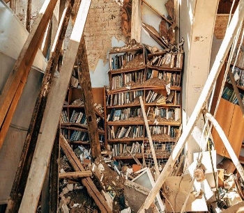 interior of destroyed building with bookshelves
