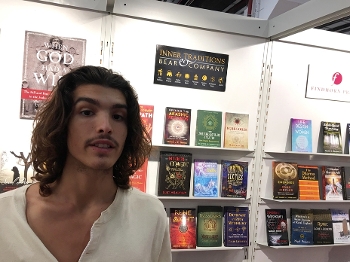 Stephen Theo stand in front of a display of mind, body, spirit books