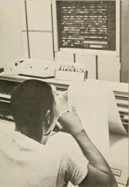 Black student seen from behind with paper