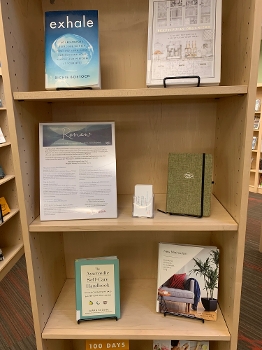 bookshelf display with wellness books, journal, Renew graphic