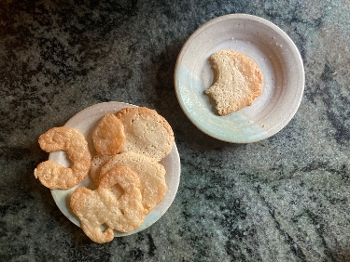 almond jumballs (cookies) on two plates on tabletop