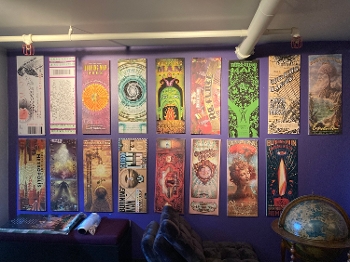 wall with Burning Man posters displayed